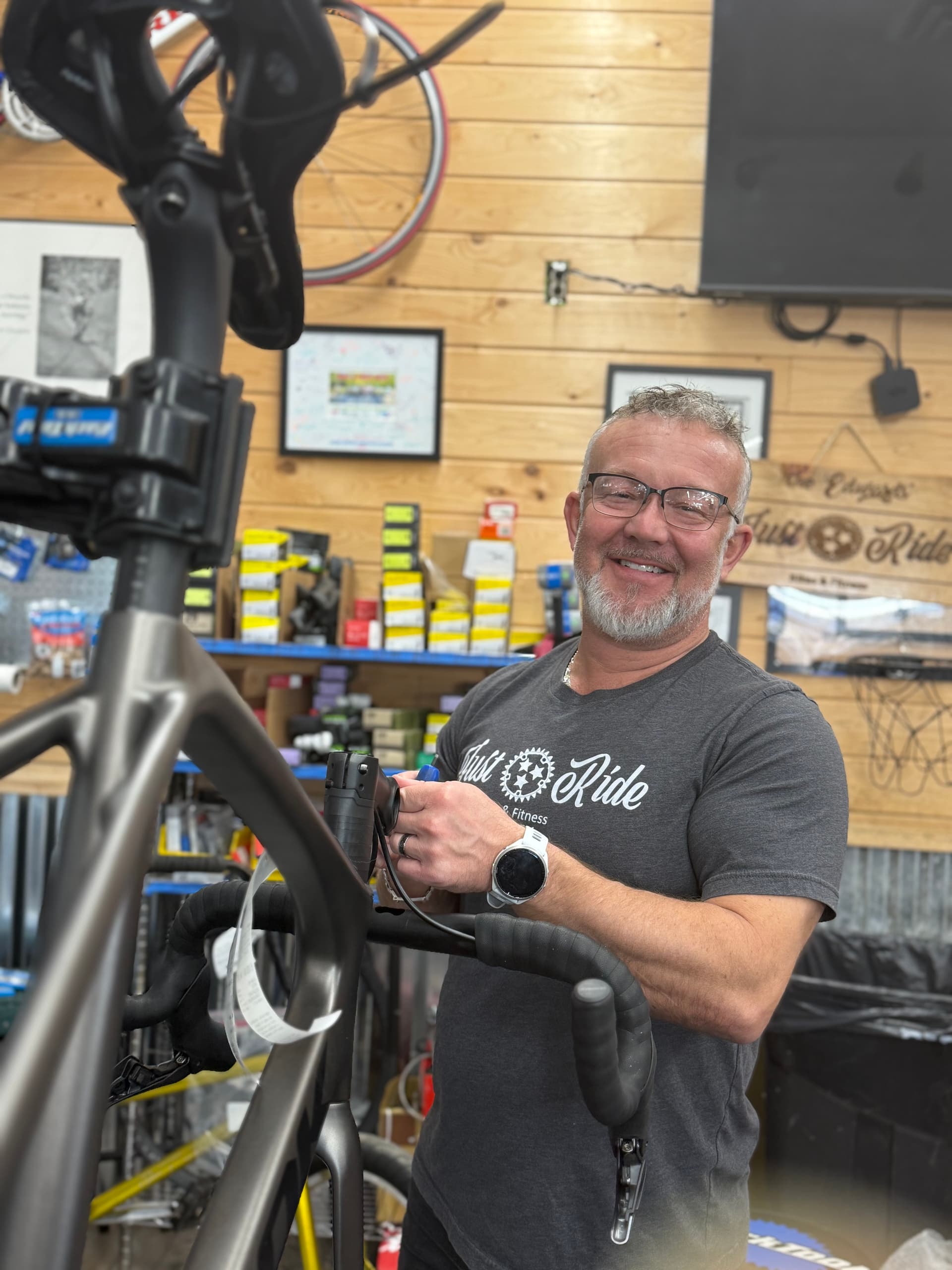 Brian working on a road bike in the repair stand at Just Ride