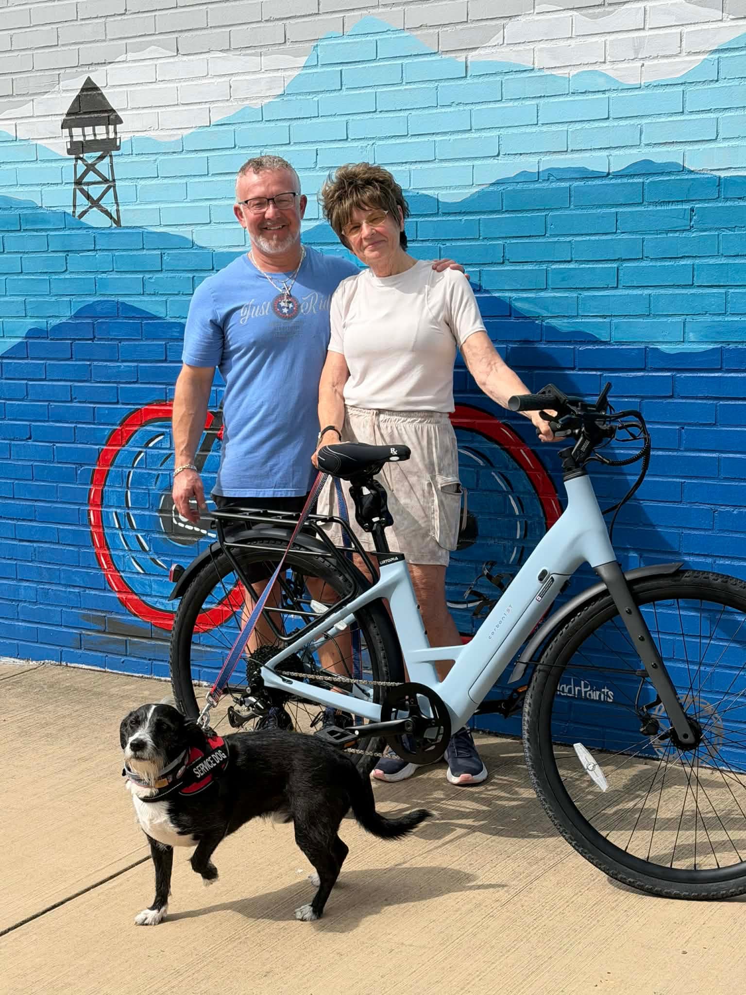 A Just Ride customer with their new bike outside the shop