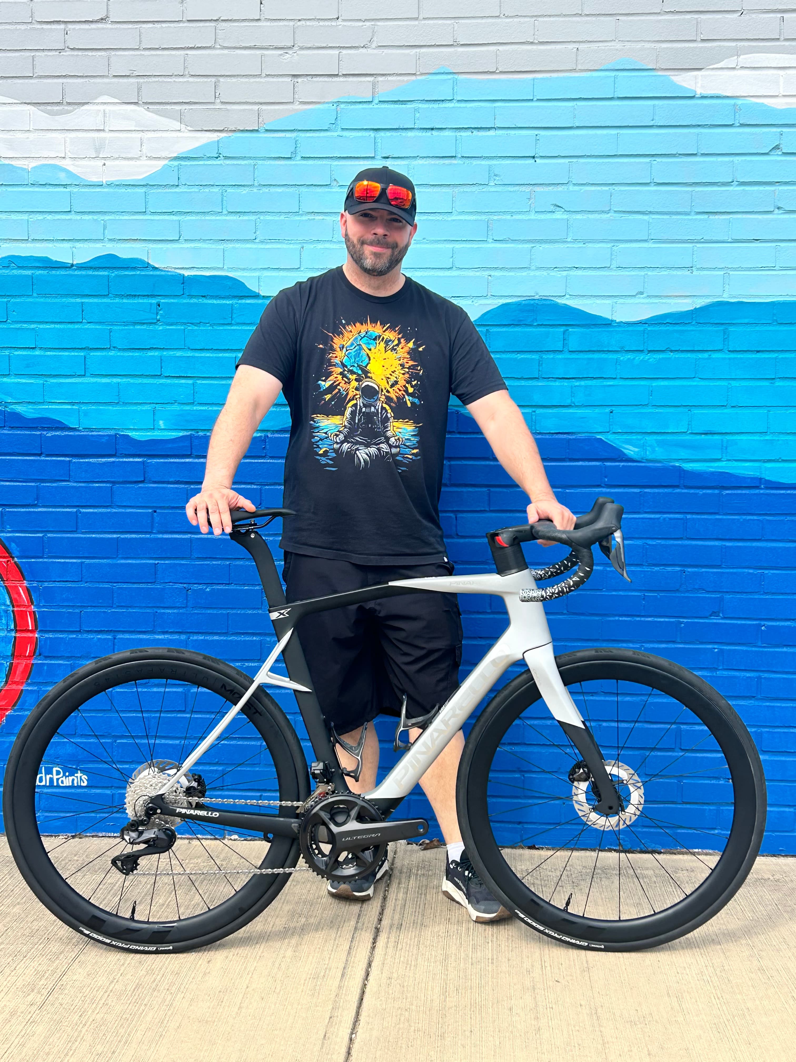 A Just Ride customer with their new bike outside the shop