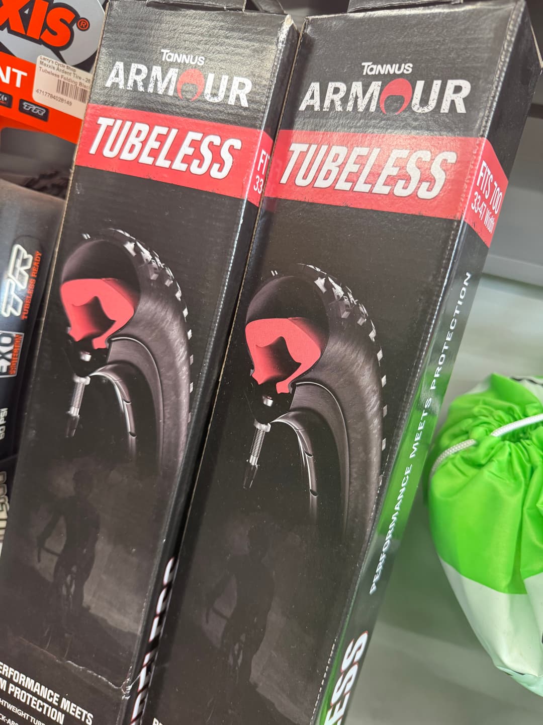 Stacked boxes of Tannus Armor Tubeless inserts on the shop shelf