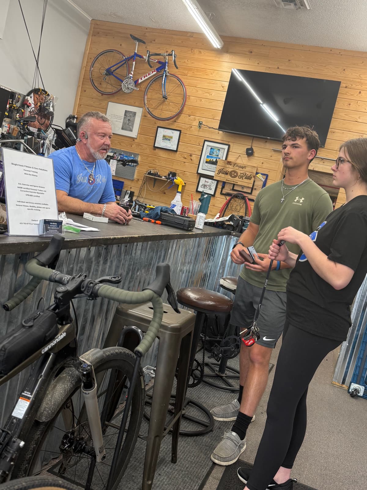 Brian talking with customers at the Just Ride counter
