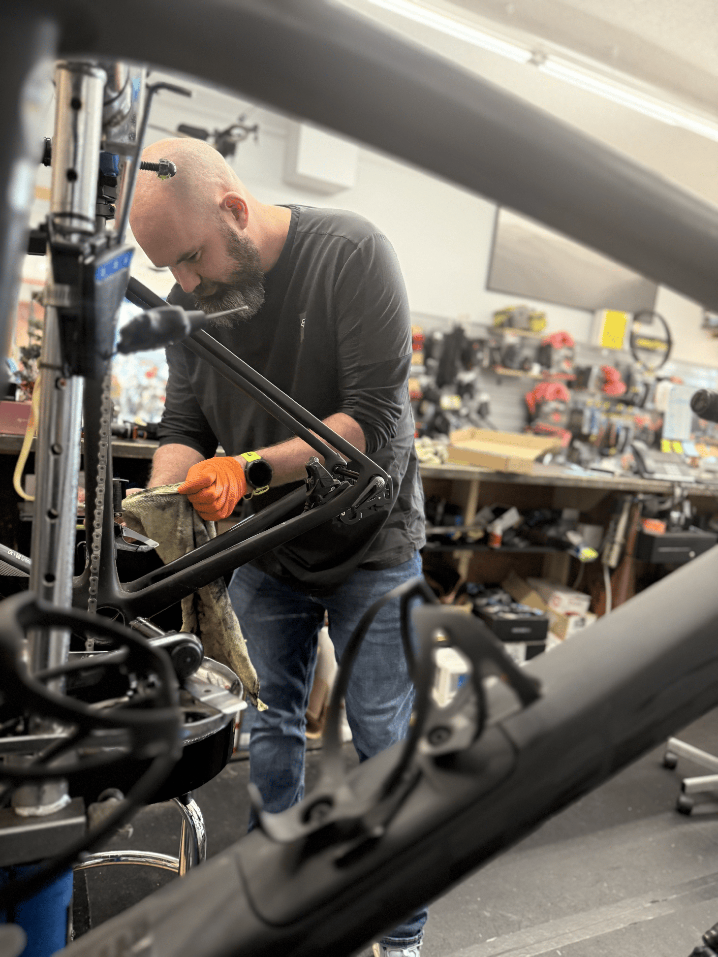 Just Ride Bikes technician servicing a bike frame in the workshop